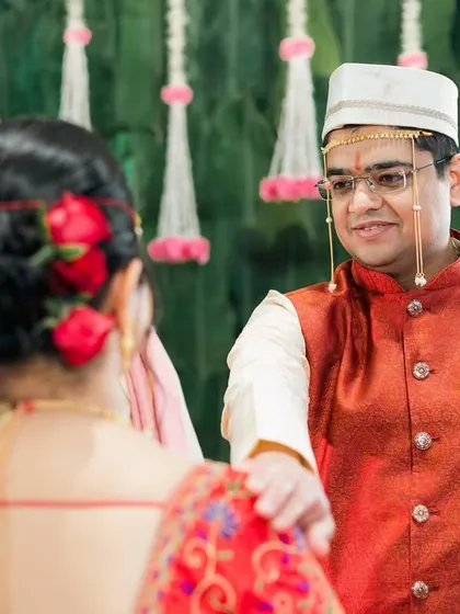 The groom's loving gaze towards his bride during their Maharashtrian wedding.