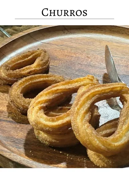 Freshly made churros, crispy on the outside and soft on the inside. Dusted with cinnamon sugar, they are perfect for dipping in a rich chocolate sauce.