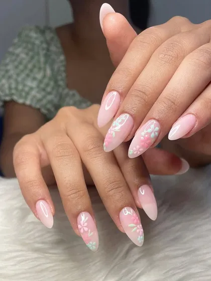 Holding on to summer with these dainty nails. This set features a soft pink ombré base on almond-shaped extensions with delicate, hand-painted pastel flowers.