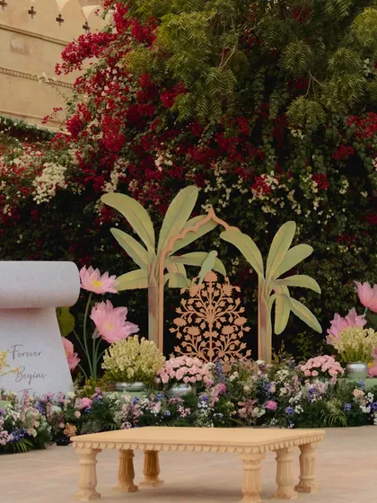 A detail of the wedding setup, featuring hand-painted banana tree cutouts and a Kalpavriksha (tree of life) motif, blending artistic elements with natural beauty.