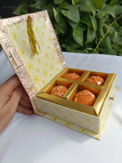 A closer look at the 4-piece laddoo candle gift box. The drawer-style box with a tassel is designed to feel luxurious and makes for a perfect festive present.