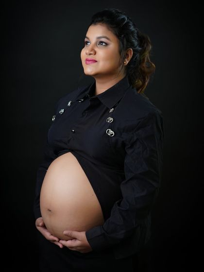 A hopeful and serene solo portrait. The mother-to-be looks upward, creating a sense of peaceful anticipation for the future with her new baby.