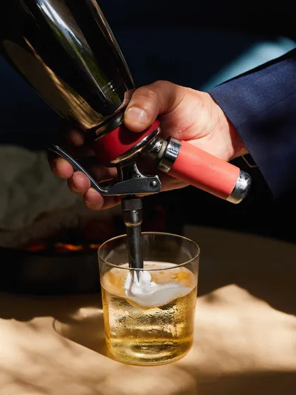 Adding the finishing foam to our Cuban Sour. This detail gives the cocktail its signature creamy texture, balancing the crispness of the spirit.