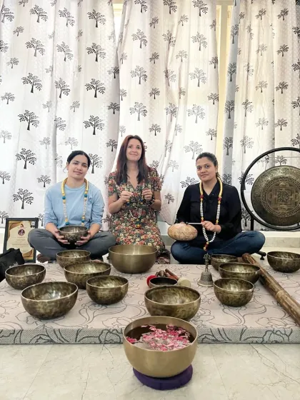 A group of students celebrates their graduation from the sound healing course, ready to share their knowledge.