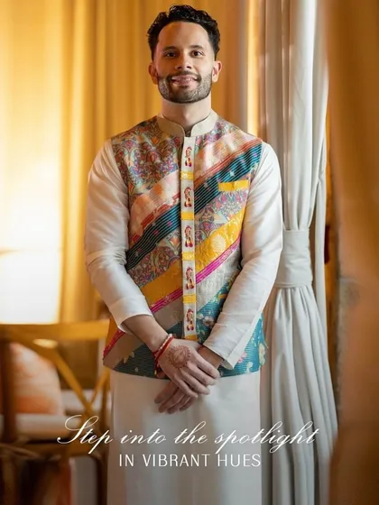 Step into the spotlight in vibrant hues. For his Sangeet, we styled the groom in a classic kurta pajama elevated by a colorful patchwork Nehru jacket, a look that is both traditional and full of personality.