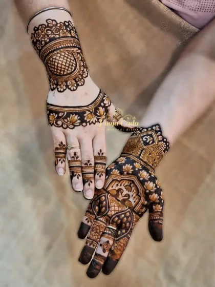 A bold and beautiful siders design for the back of the hands. One hand features a large, shaded mandala, while the other has a more traditional pattern with a peacock, showing how different styles can be combined.