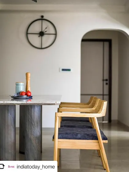 The dining area of 'Cedar Abode', as seen in India Today Home. The minimalist design is elevated by the custom table and the elegant archway in the background.