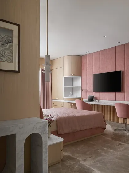 I designed this kid's bedroom to be bright and joyful, fulfilling the request for 'bright pink'. The upholstered wall panel behind the TV and the long marble desk provide a functional and stylish space for both entertainment and study.