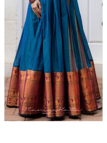 A detail of the Yale blue dress's hem, featuring a rich border with traditional woven patterns.