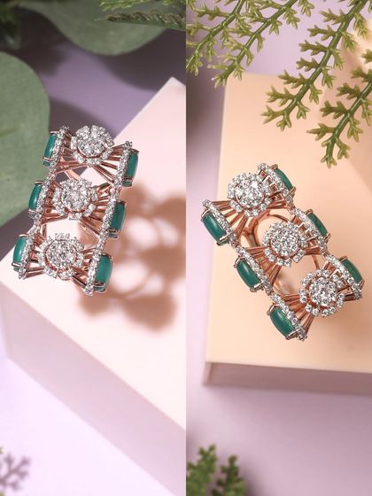 Showcasing an intricate green-stoned ring. The split image displays the piece from two different angles against a clean, geometric background, emphasizing its unique design.