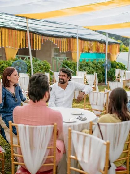 A candid moment of the groom chatting with guests, showing that I capture the entire atmosphere of the wedding day.