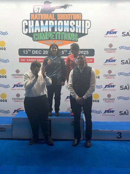 Officials applauding our shooter on the podium at the National Championships. Such recognition is earned through hard work and exceptional performance.