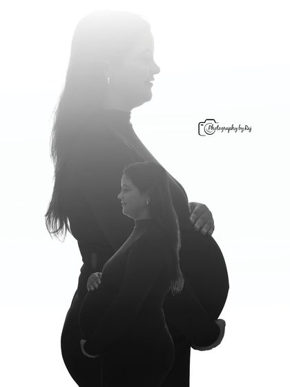 A creative double-exposure silhouette, capturing the profiles of both parents-to-be.