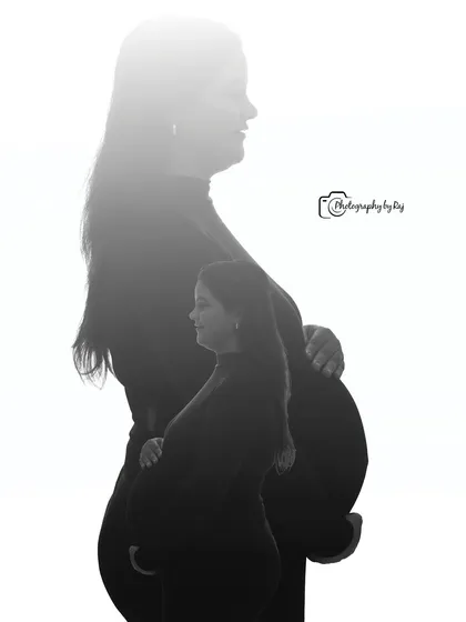 A creative double-exposure silhouette, capturing the profiles of both parents-to-be.
