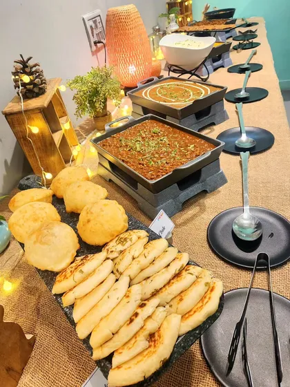 A glimpse of our delicious buffet spread for adults. I serve fresh, hot food like chole, naan, and poori, ensuring everyone is well-fed.