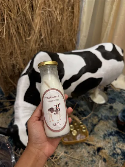 "Prahaan's Farm Fresh Milk," a charming and thematic beverage served in vintage-style glass bottles.