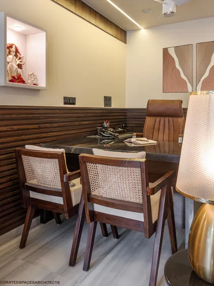 Details matter. I chose vintage-style chairs with cane webbing and rich, fluted wood paneling to add texture and character. These elements come together to create a sophisticated and comfortable workspace for my client.