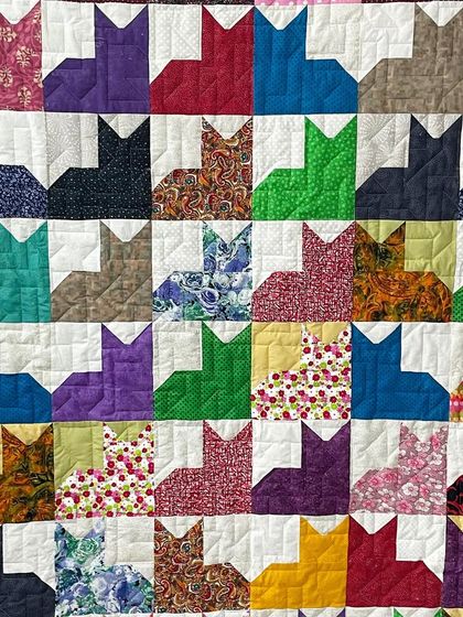 Another detail shot of the cat-themed quilt, perfect for any animal lover.