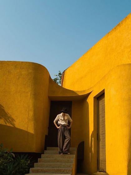 A guest stands on the steps, providing a sense of scale to the building's grand yet welcoming entrance.