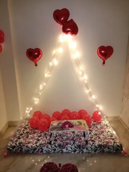 You don't need a huge budget for a beautiful surprise. This is my popular budget-friendly cabana setup, perfect for a 6-month anniversary or just a special evening, complete with fairy lights, heart balloons, and a small table for two.