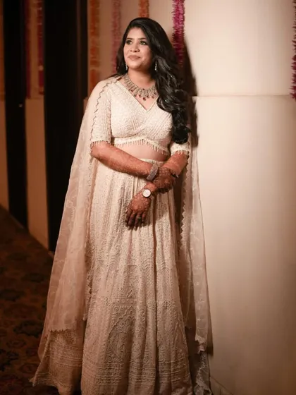 The full look for Pooja's sangeet. The elegant ivory lehenga and soft glam makeup created a look of pure sophistication.