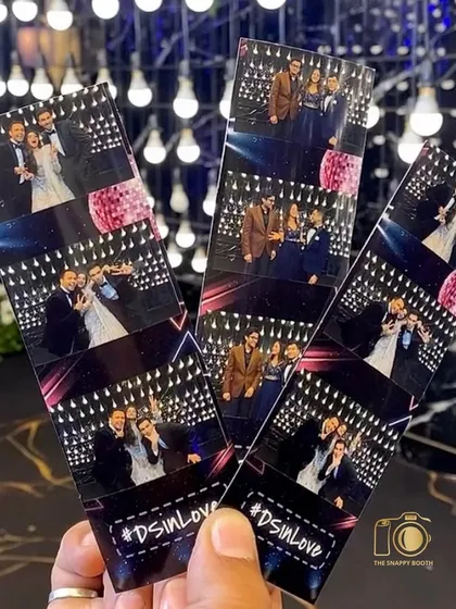 Instant gratification! A guest holding up the classic photo strips from our booth, featuring fun moments from the #DSinLove party.