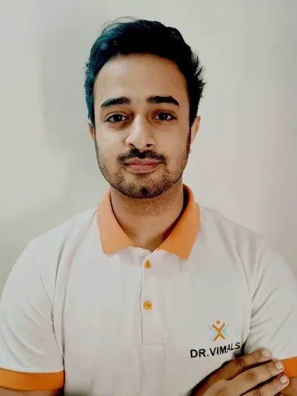 A portrait of Dr. Godin S. Kuruvilla, a distinguished consultant physiotherapist with specialized experience in sports medicine and manual therapy. He is also a trainer, mentoring the next generation of physiotherapists.