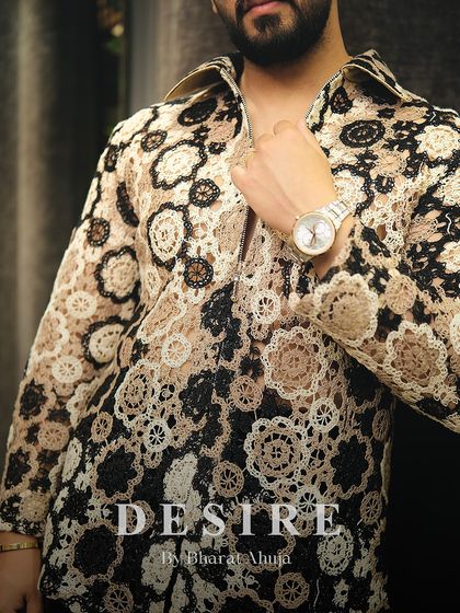 A detail shot of the crochet-style shirt, focusing on the texture and the warm, earthy color palette.