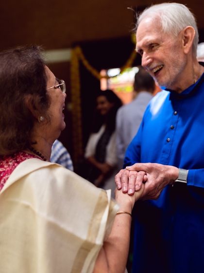 Nayaswami Jyotish shares a joyful moment with a devotee. Our teachers are approachable and loving, fostering a sense of divine friendship and offering personal blessings and guidance.