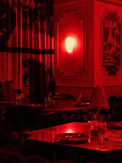 Another detail of a dining corner, where the warm glow of a wall sconce highlights the intricate wall moldings.