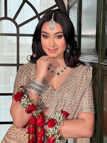 A portrait of elegance. This bride's soft glam makeup, with its neutral tones and subtle shimmer, is perfectly balanced by her statement emerald and diamond jewellery.