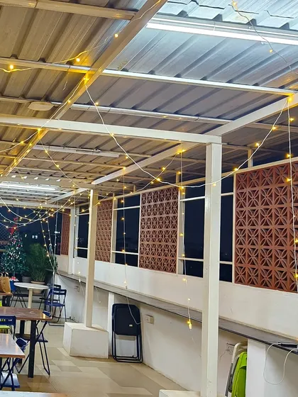 A wider shot of the festive decor at the Bizom office. You can see how the string lights span the entire length of the semi-outdoor space, ensuring the whole area feels warm and inviting.