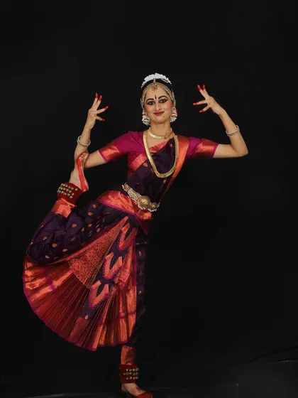 I love the process of selecting costumes. We go through sarees, considering colors and patterns to find something that suits the student's personality, like this beautiful purple and red combination.