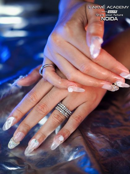 Another angle of the beautiful white nails, showing the delicate 3D floral details.
