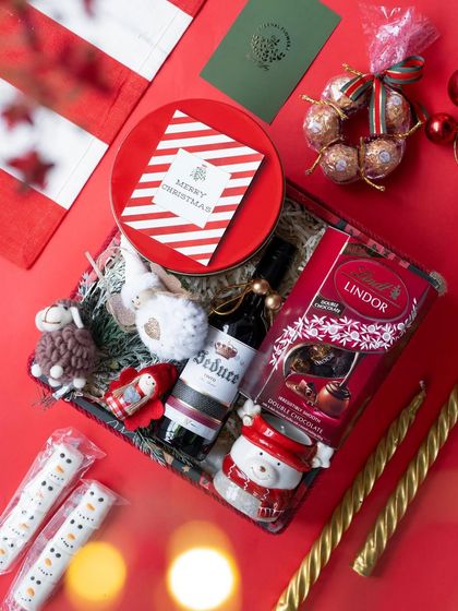 Another view of the 'Santa's Sweet Retreat' hamper, showcasing its rich red and gold color scheme.