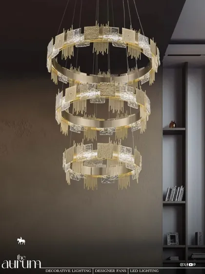 This three-tiered ring chandelier is a masterclass in modern grandeur. I love how the textured glass and brushed gold rings create layers of light, making it a perfect anchor for a spacious living area or a hotel lobby.