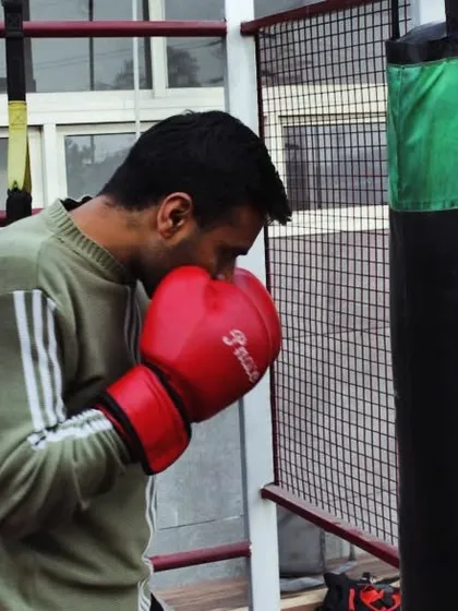 This is me during a boxing training session with a heavy bag. I teach proper kickboxing and boxing techniques for fitness and self-defense.