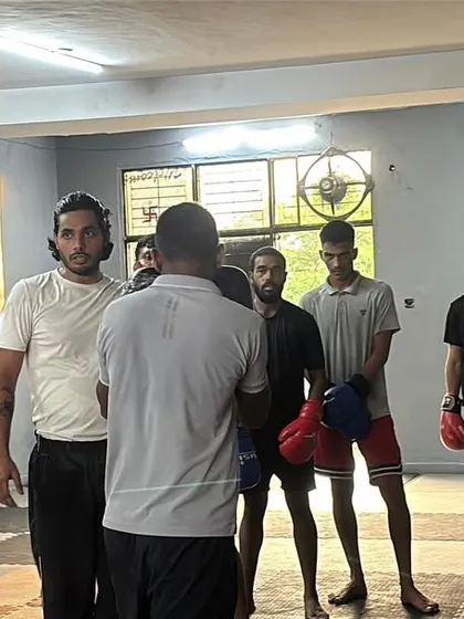 A moment of instruction during a group session. I believe in direct feedback, ensuring every student understands the technique and purpose behind each drill before we begin.