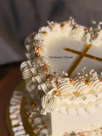 Another angle of the heart-shaped Lambeth cake, highlighting the delicate scrollwork.