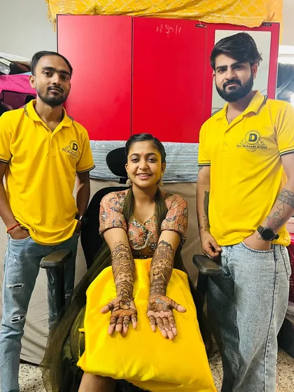 The full team with a happy client. We work together to ensure that even for large wedding parties, our work is quick, clean, and beautiful.
