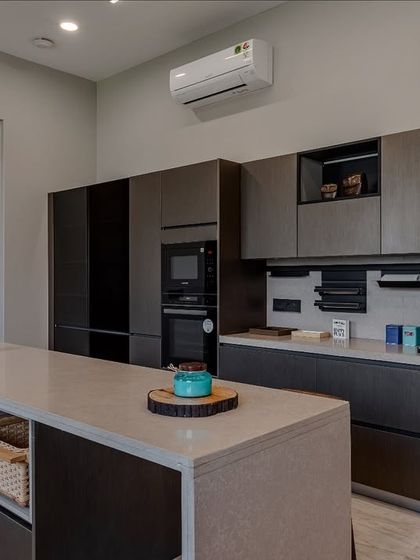 This view shows the integration of Blaupunkt appliances and smart storage solutions, including open shelving within the cabinet run for easy access to everyday items.