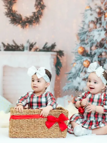 Twin sisters enjoying our Christmas setup. We have props and setups that are perfect for capturing the magic of the holidays with your little ones.