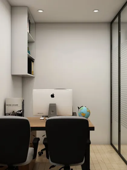 This rear view of the cabin's workspace highlights the clean, minimalist setup with a large monitor and an uncluttered desk, ideal for focused work. The glass wall maintains a connection to the larger office.