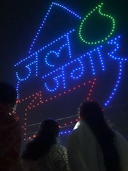 The logo for 'Jal Jagar' created with drones, seen by an engaged crowd. Our shows are an effective medium for spreading awareness on important social issues.