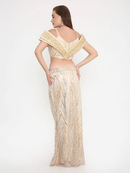 A look that's stunning from every angle. The back of our golden shimmer outfit shows the impeccable fit and detailed handwork that goes into every custom piece.