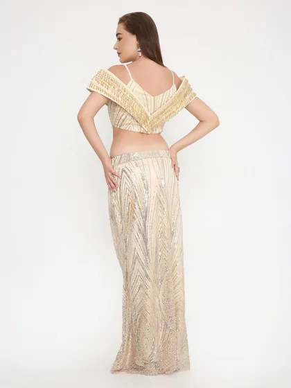 A look that's stunning from every angle. The back of our golden shimmer outfit shows the impeccable fit and detailed handwork that goes into every custom piece.