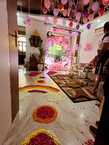 A grand 'Welcome Baby' decoration I did for a family. The entrance hallway was decorated with a beautiful pathway made of fresh flower petal rangoli, leading to a balloon arch and a fully decorated room to welcome the newborn.