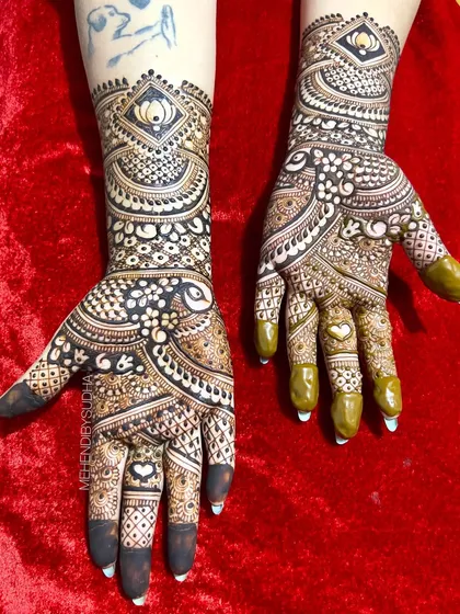 The full view of the bold and beautiful engagement mehendi, with a heart hidden in the palm.