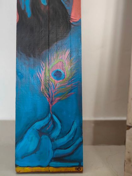 A detail of the hands holding the peacock feather in my Krishna painting. The gesture is soft and mindful, signifying a gentle engagement with the present moment.