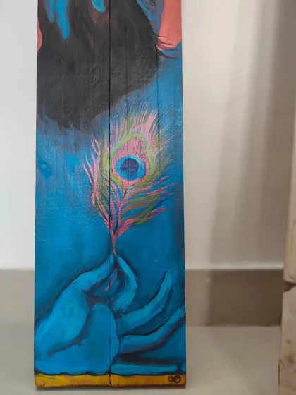 A detail of the hands holding the peacock feather in my Krishna painting. The gesture is soft and mindful, signifying a gentle engagement with the present moment.
